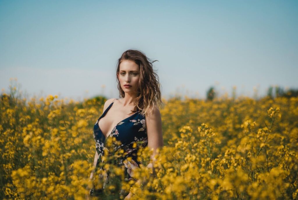 Mesmerizing blond haired east european woman in a field of flowers.