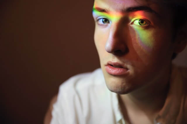 gay guy with pride and rainbow colours across his face