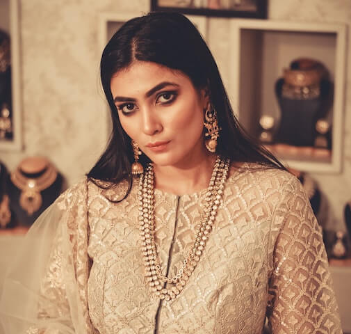 A southern Desi  woman dressed in traditional religious gown. 