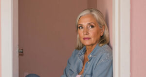 Confident elderly woman smiling in soft daylight
